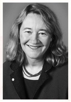 a black and white photo of a smiling woman