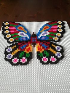 a butterfly made out of legos sitting on top of a table