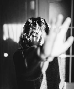 black and white photograph of woman making hand gestures