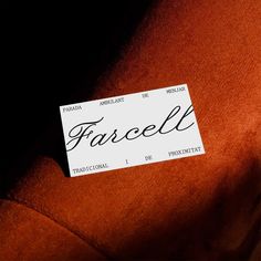 a name tag is attached to the back of an orange shirt that reads, fascell