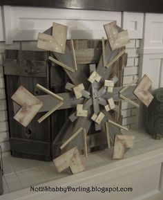 a wooden snowflake sitting on top of a fireplace