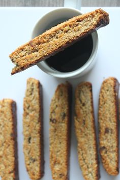 an image of some cookies and coffee on a white table with the top half cut off