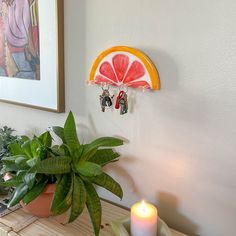 a potted plant sitting on top of a wooden table next to a candle holder