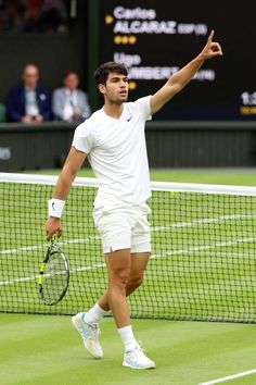 a man holding a tennis racquet on top of a tennis court