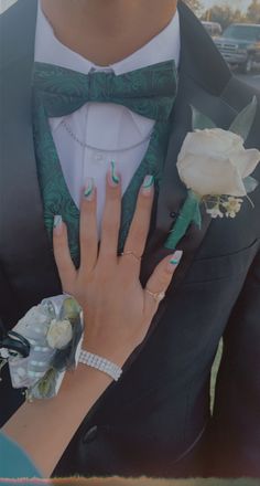 a man in a tuxedo with his hands on the woman's lapel