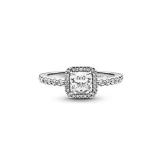 a white diamond ring with diamonds on the sides and an halo setting in the middle