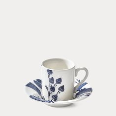 a cup and saucer with blue flowers on it