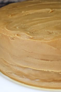 a cake with frosting sitting on top of a white plate