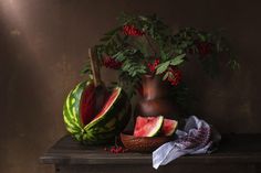 a watermelon and other fruits on a table