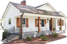 a small white house with wooden shutters and porch chairs on the front steps leading up to it