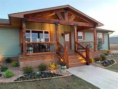 the front porch of a house with lights on and steps leading up to it's second story