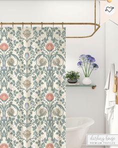 a shower curtain with flowers on it next to a bathtub and toilet in a bathroom