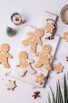 some cut out ginger cookies on a white table