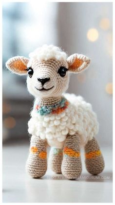 a crocheted sheep is sitting on the floor