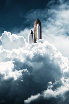 black and white photograph of a space shuttle in the clouds