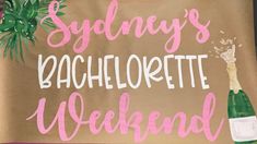 a brown bag with the words sydney's bachelor weekend on it and a bottle of champagne