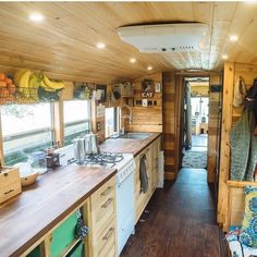 the interior of a tiny house with wood flooring and walls, along with wooden counter tops