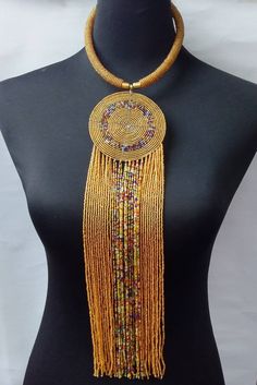 African beaded necklace made with maasai beads. Its a perfect accessory that will match most of your outfits. Suitable for any season. A good gift to your friends and loved ones. All our items are shipped through DHL Express. Delivered between 3 to 5 days. Luxury Gold Fusion Beaded Necklaces, Eye-catching Multicolor Necklace With Gold Beads, Multicolor Beaded Necklaces With Gold Beads For Festivals, African Beaded Jewelry, African Necklaces, African Beaded Necklace, Fantasy Jewellery, African Jewellery, African Beads Necklace