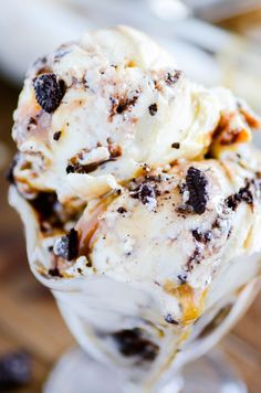 an ice cream sundae with raisins and chocolate chips in a glass dish