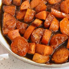 cooked sweet potatoes in brown sauce in a pan