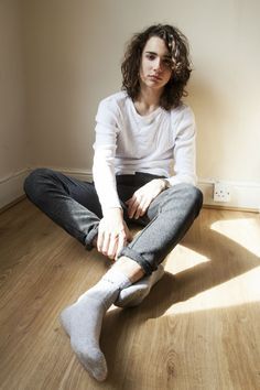 a woman sitting on the floor with her legs crossed