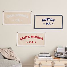 three signs are hanging on the wall above a suitcase