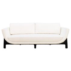 a white couch sitting on top of a wooden frame