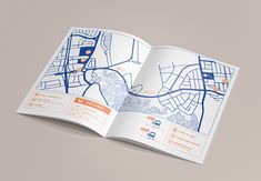 an open book with a map on the front and back pages in orange, blue, and white