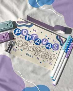 there are some pens and pencils on top of a paper with the words potato's scrabbles