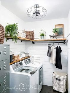 a washer and dryer in a laundry room with open shelving on the wall