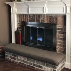 a fireplace with a bench in front of it