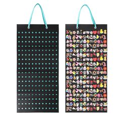 two black shopping bags with colorful stickers on them