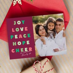 a christmas card with the words joy love peace hope cheer on it next to some candy canes