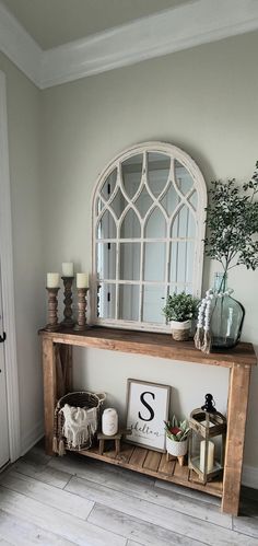 an entryway with a wooden shelf and mirror