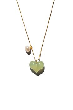 The Puffed Heart Necklace features a green jade heart pendant, puffed to perfection, complemented by a delicate pearl. The unique puffed design of the jade heart adds a playful touch, making it an irresistibly cute accessory.  Length: 17.5" Heart pendant: 10mm x 13mm x 5mm Material: Nephrite, pearl, gold-plated sterling silver Jade Heart Necklace, Puffed Heart Necklace, Puffed Heart, Pearl Pendant Necklace, Jade Stone, Green Necklace, Green Jade, Jade Green, Pearl Pendant