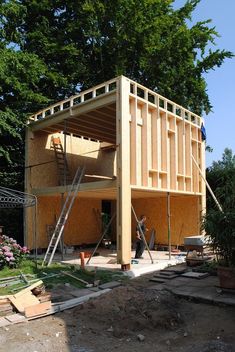 a house being built in the middle of a yard with some stairs going up to it