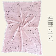 a pink crocheted blanket with the words good morning written in white on it