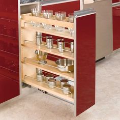 an open cabinet in a kitchen with pots and pans on the bottom shelf,