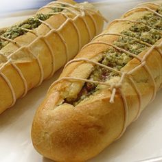 two hot dogs wrapped in bread with toppings