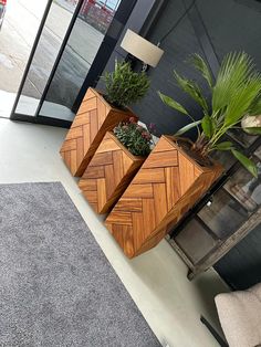 two wooden planters with plants in them sitting on the floor next to a window