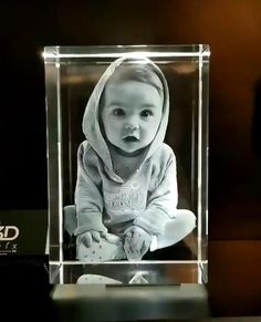 a glass block with an image of a baby in it's hoodie on