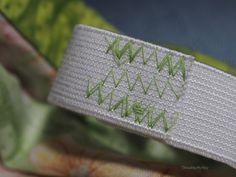 a white wristband with green writing on it