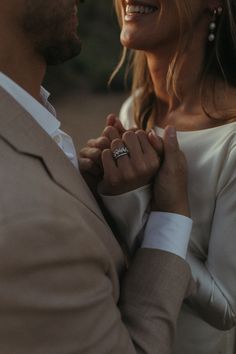 a man and woman holding each other's hands