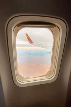 an airplane window looking out at the ocean