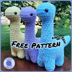 three crocheted llamas sitting next to each other on a wooden table