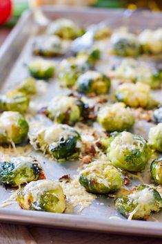 brussel sprouts with bacon and cheese on a baking sheet ready to be cooked