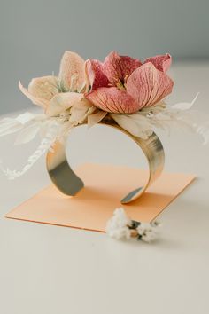 a bouquet of flowers is sitting on top of a card