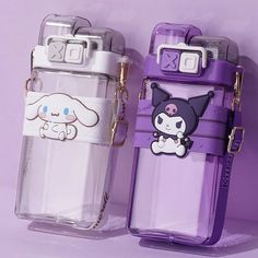 two purple and white cell phones sitting next to each other