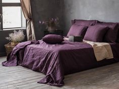 Linen bedding set in Purple/Plum color. The set includes 1 duvet cover and 2 pillowcases, available in various sizes  Experience the pinnacle of elegance and craftsmanship with our premium linen bedding set in a striking plum shade. This artisan-crafted collection is not just a bedding ensemble but a testament to the timeless art of hand dyeing and tailoring. Rich, Deep Hue: Each piece is individually hand-dyed, resulting in a unique and captivating plum shade that evokes a sense of sophistication and warmth. The variations in tone celebrate the artisan's touch, ensuring no two sets are exactly alike. Unparalleled Comfort: The natural properties of linen provide a breathable, soft texture against your skin, ensuring both comfort and a rejuvenating sleep. Over time, this fabric only grows s Dark Plum Bedding, Linen Bedding Styling Purple, Eggplant Duvet Cover, Purple Velvet Duvet Cover, Plum King Size Bedding, Duvet Covers Floral, Ruffle Duvet Cover, Duvet Cover Queen, Linen Comforter