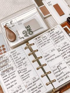 an open planner book sitting on top of a table